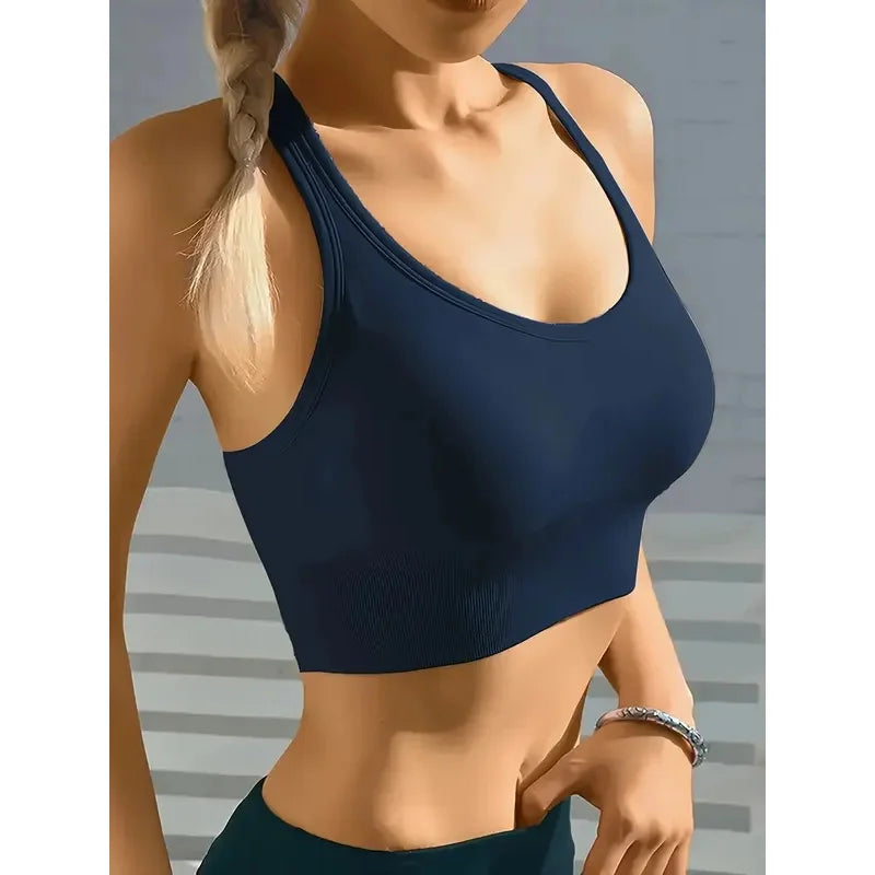 Person wearing a black sports bra against a gray background