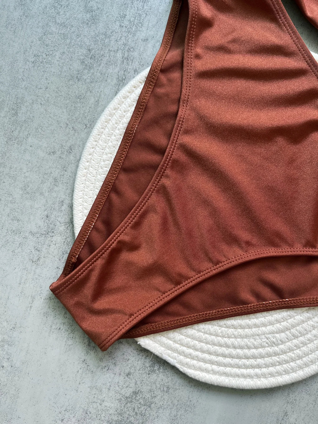Brown bikini bottom on a textured surface