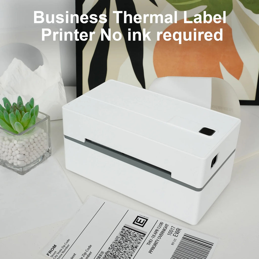 White thermal label printer on a desk with office supplies in the background